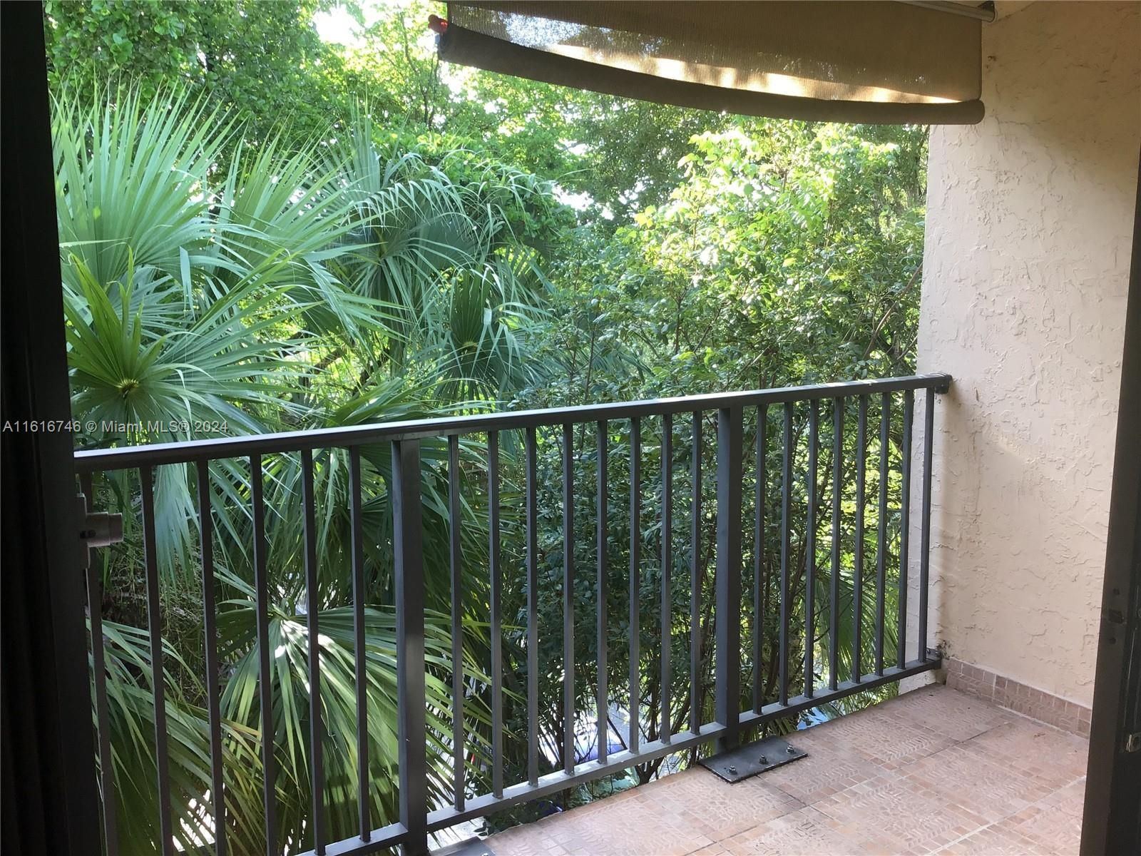 Storage room within balcony contains washer/dryer