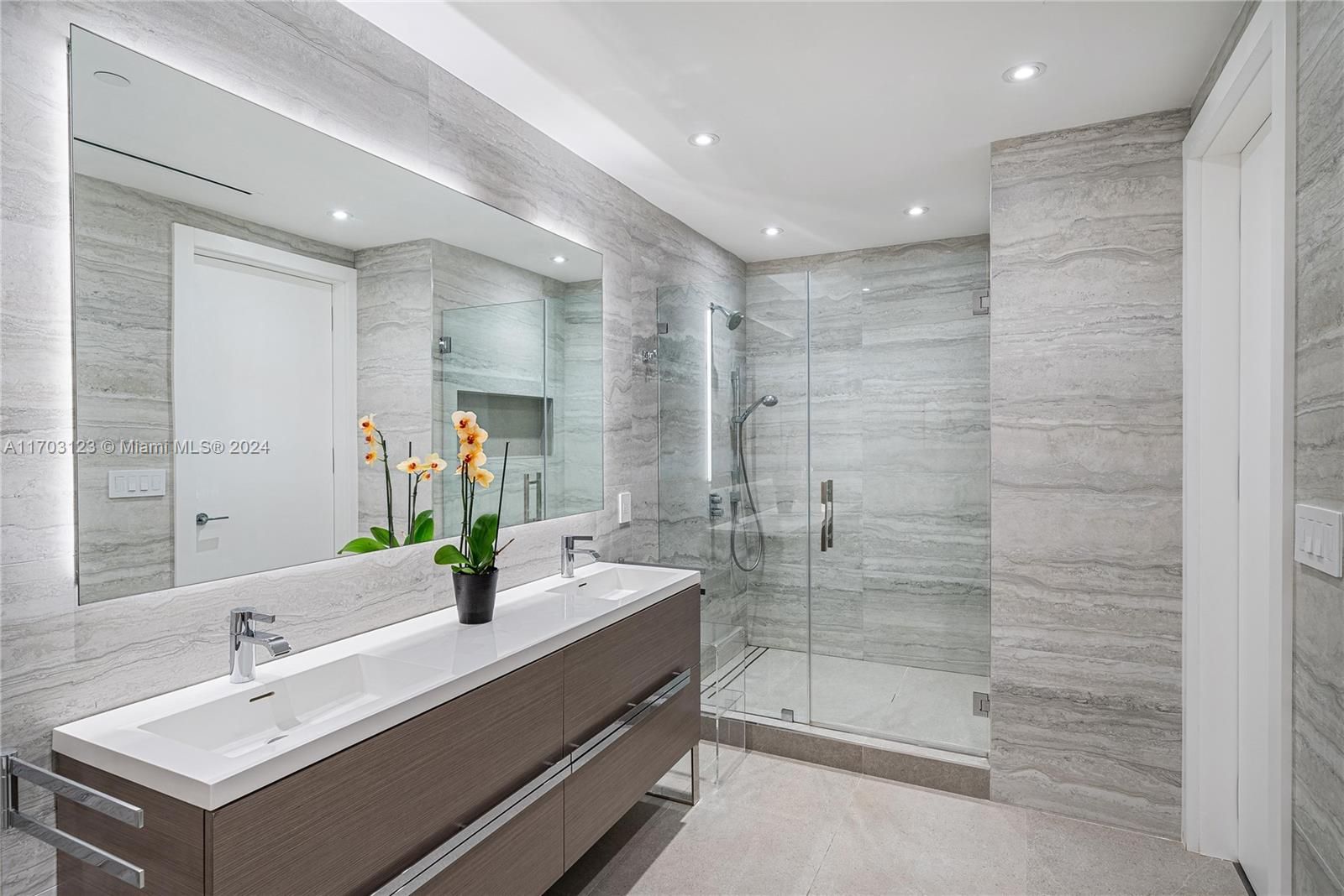 Fully Custom Primary Bathroom Upgraded with Procelain Stone, Backlit Mirror, Stand Alone Tub.